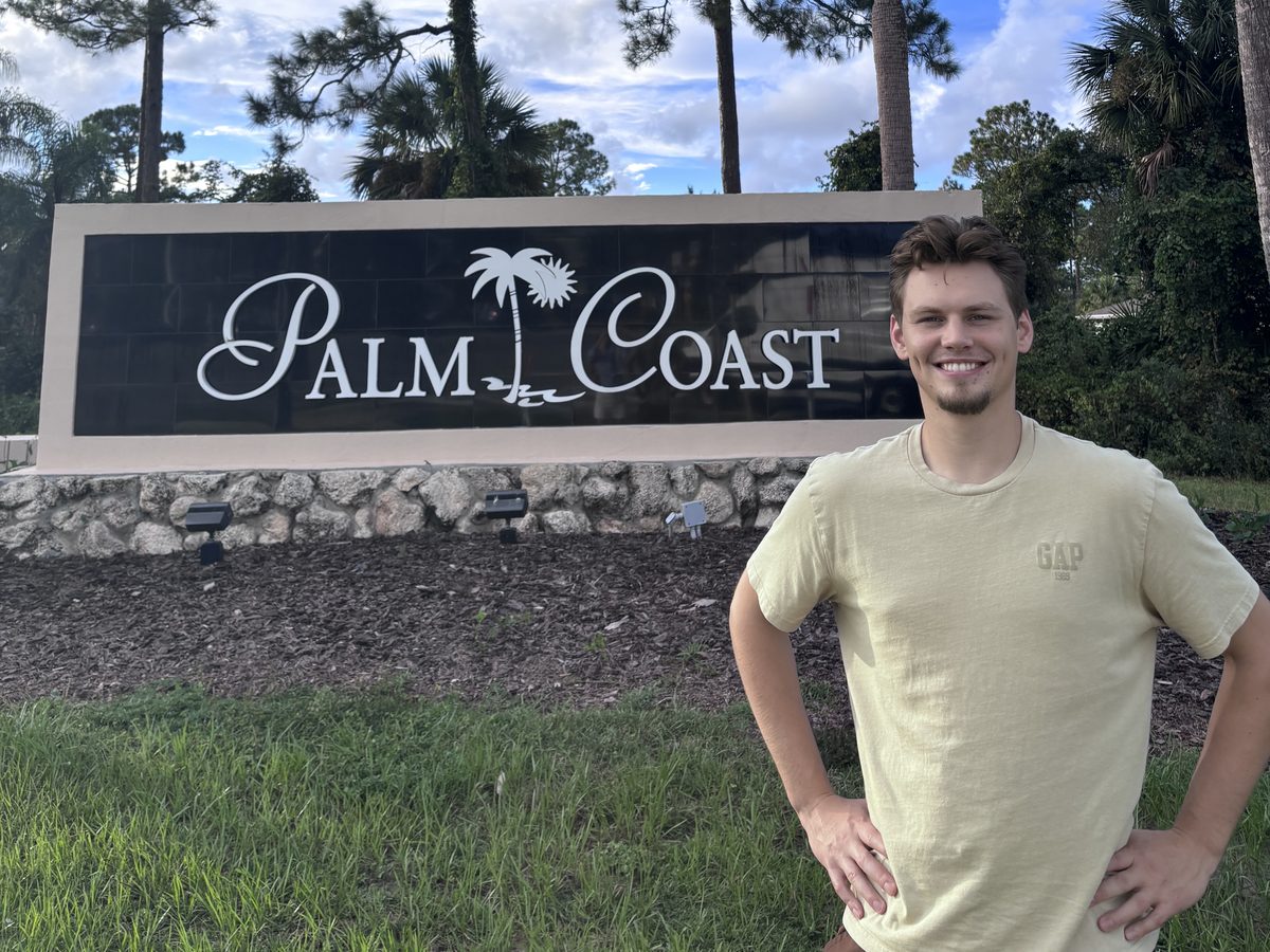 Max Kutsar, founder of Find Untapped Growth, at the Palm Coast city sign